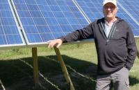 Dan Juhl with solar panels. Photo by MPR News